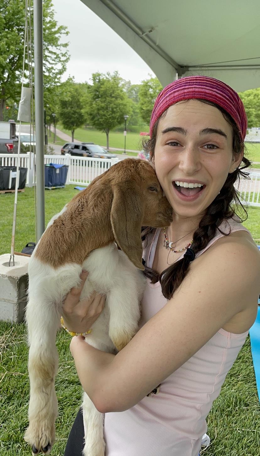 Picture of intern, Julia Tomalis with a baby goat